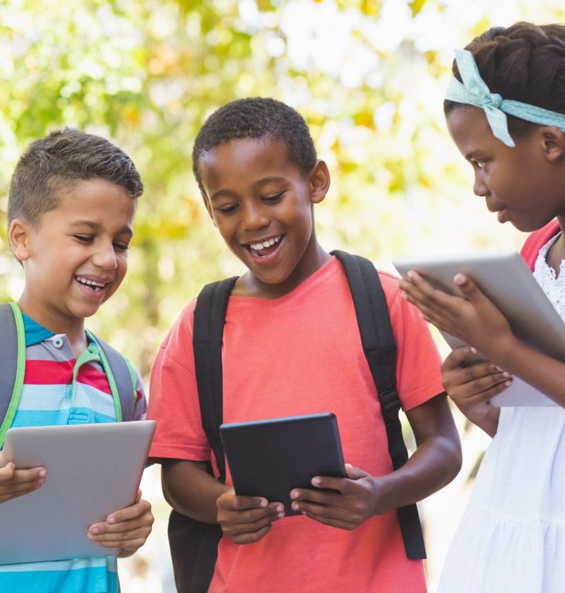 School kids using digital tablet at school campus